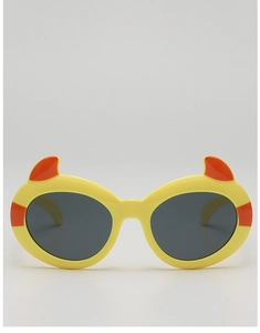 Close-up of yellow cartoon devil sunglasses for kids with cute orange horn accents