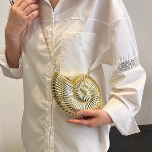 Elegant gold nautilus shell clutch bag with metallic texture and sleek chain strap