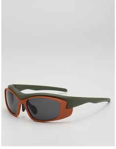 Detail view of orange and green wrap-around kids sports sunglasses with grey lenses