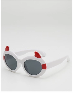 Close-up of white oval frame kids sunglasses with red devil horns and dark grey lenses