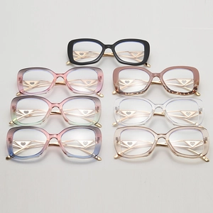 Detail showing colorful large frame glasses with golden heart and triangle hollow temples