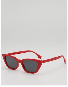 Detail view of red cat-eye kids sunglasses with dark grey lenses on grey background
