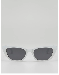 Detail view of foldable cat-eye sunglasses with translucent matte white frames and dark gray lenses