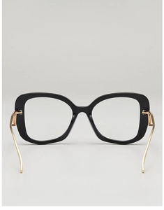 Detail of black oversized eyewear frames with elegant gold metal temples for women