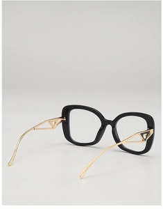 Detail of black glasses frame with gold hollow triangular temples and heart accents