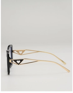 Detail of metal glasses frame showing hollow geometric temples and heart-shaped accents