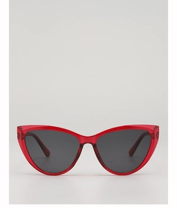 Close-up of trendy cat-eye sunglasses with translucent red frames and dark grey lenses