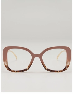 Macro shot of oversized pink gradient and tortoise shell frame with slim gold metal legs