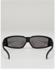 Close-up of black glossy wrap-around sports sunglasses with dark grey Y2K style lenses