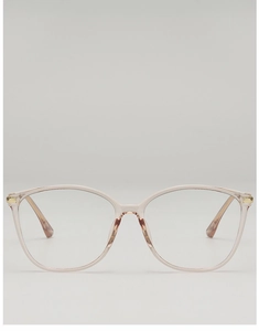 Detail of transparent pink eyeglass frames with elegant gold metal hinge accents