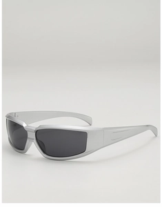 Detail view of silver frame Y2K sunglasses with dark lenses and futuristic streamlined arms