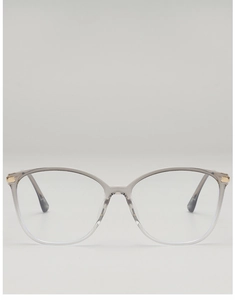 Detail of transparent grey cat-eye frames with golden metal hinge accents and sleek design