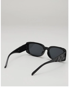 Detail of black square sunglasses with textured geometric diamond pattern on wide temples