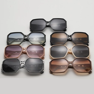 Various colors of oversized geometric sunglasses with hollowed chain detail on temples