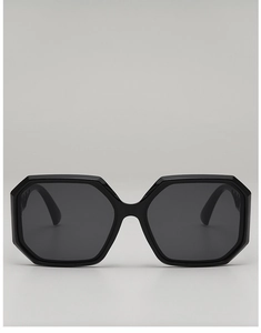 Detail of polygonal oversized sunglasses with cutout temples and dark gray lenses