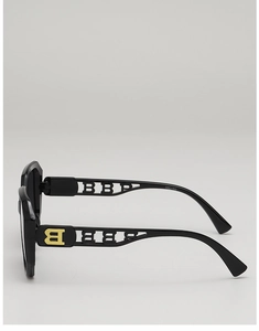 Close-up of wide sunglasses temple with hollowed-out pattern and golden B logo detail