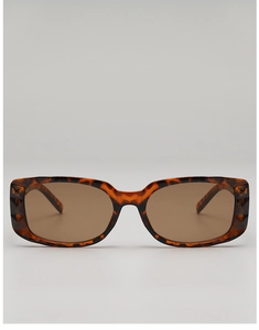 Detail of tortoise shell sunglasses featuring geometric faceted edges and brown lenses
