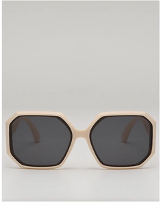 Detail of cream oversized polygonal sunglasses showing hollowed temple design and grey lenses