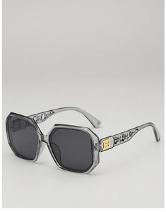 Close-up of geometric square sunglasses featuring a golden B logo and hollow textured temples