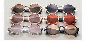 Macro display of six vintage round sunglasses with textured metal frames and multi-color lenses