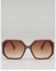 Close-up of hexagonal matte pink sunglasses with gradient lenses and hollowed temple detail