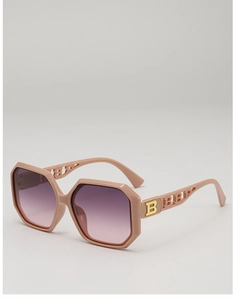 Close-up of pink polygon frame sunglasses with gradient lenses and hollow B-letter detail
