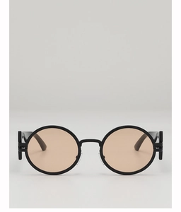 Detailed front view of retro round sunglasses with matte black frames and amber lenses