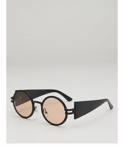 Detail view of vintage round sunglasses with black textured frames and amber lenses