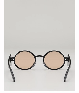 Detail of vintage round sunglasses with black frames and light orange lenses