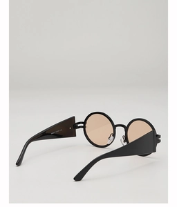 Detail view of thick black frame sunglasses with orange lenses and printed leg specs
