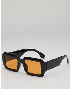 Close-up of retro square black frames with orange lenses and wide temple design