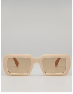 Close-up of retro cream rectangular sunglasses with thick frames and brown tinted lenses