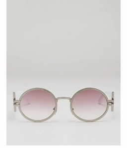 Close-up of retro round metal sunglasses with hammered texture and pink gradient lenses