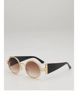 Detail of round vintage sunglasses with gold textured metal frame and brown gradient lenses