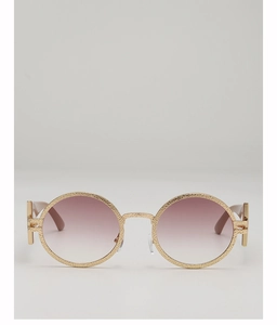 Detailed view of retro round gold sunglasses with textured frames and gradient lenses