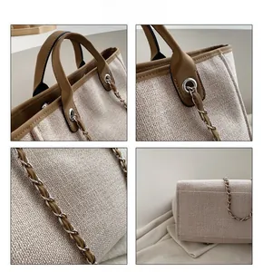 Detail view of beige woven tote bag showing silver metal chain strap and brown leather handles