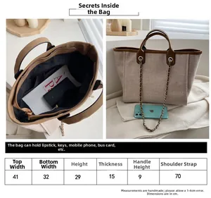 Detailed size chart for large canvas tote bag with leather straps and chain detail
