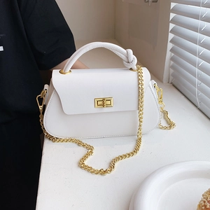 White minimalist crossbody bag with knotted handle and elegant gold chain strap
