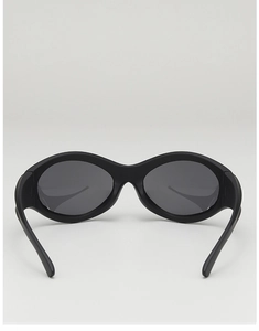 Detail showing the matte black oval frame and dark grey lenses of these Y2K punk sunglasses