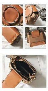 Detail view of vintage crossbody bag showing metal ring handle and interior compartments