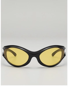 Close-up of punk Y2K sunglasses with black frame and bright yellow transparent lenses