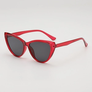 Retro cat-eye sunglasses with translucent red frames and dark grey protective lenses