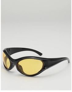 Close-up of sporty punk Y2K sunglasses with black frames and vibrant yellow lenses