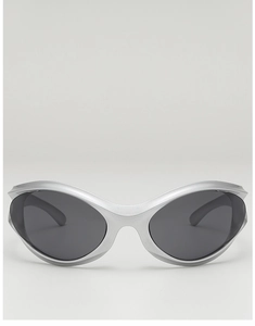 Close-up of matte silver Y2K punk sunglasses with wrap-around frame and dark lenses