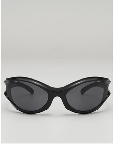 Detail of black futuristic wraparound sunglasses with sleek high-gloss frames and dark lenses