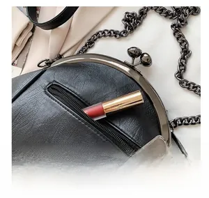 Close-up of litchi textured shoulder bag featuring a functional hidden back zipper pocket