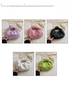 Detail of five mini pleated cloud bags in purple pink black white and green faux leather