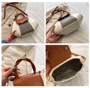 Detail view of tri-color leather handbag featuring twisted handles and metal feet studs