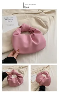 Detail of pink pleated handbag showing knotted handle and cloud-like soft faux leather
