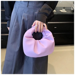 Close-up of a lilac pleated knot handbag featuring soft leather texture and stylish handle
